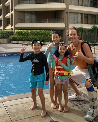 Scott Goold teaching Korean keiki how to swim