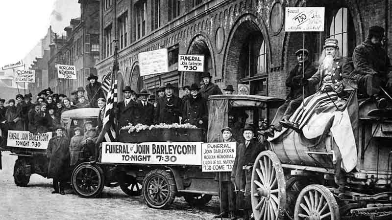 John Barleycorn's "funeral" was staged by Boston Prohibitionists in front of the Morgan Memorial Church of All Nations in the South End of Boston as the 18th Amendment's prohibition on alcohol took effect at midnight on Jan. 16, 1920. The cortege consisted of eight auto trucks containing 125 cheering and shouting men, women and children, and a city water wagon that featured "Uncle Sam." (The Boston Globe Archive via Getty Images)